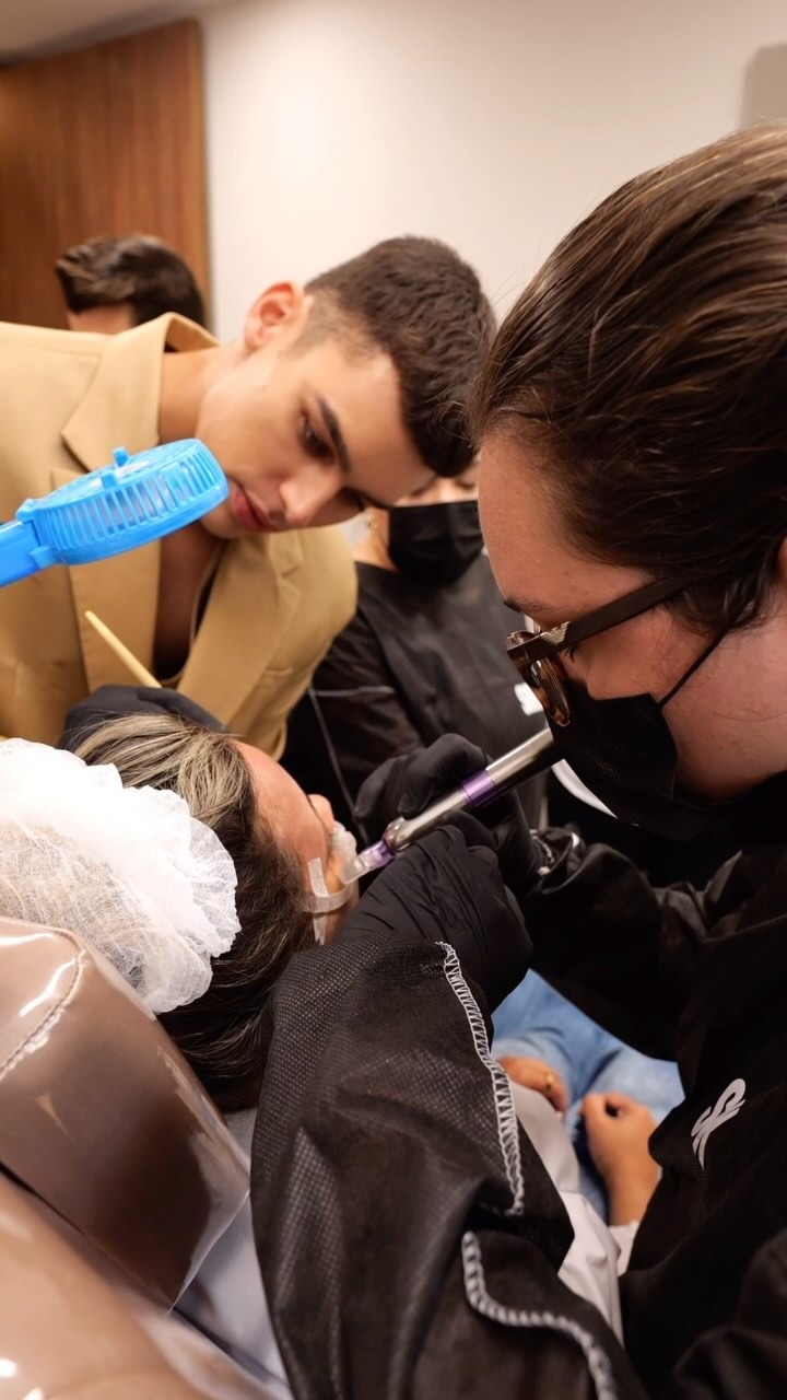 Close-up of a peel application, with the class gathered around the patient